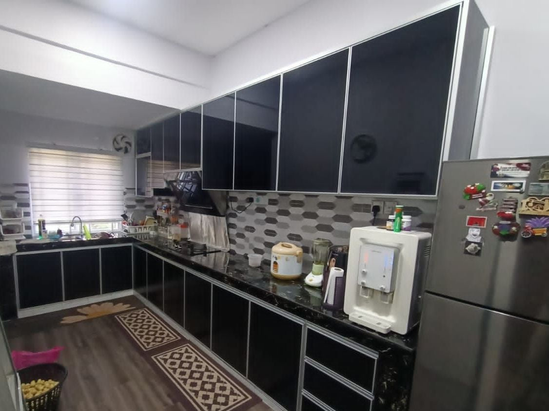A dark grey kitchen in an occupied home with a patterned backsplash, a fridge, a ceiling fan and a floor mat.
