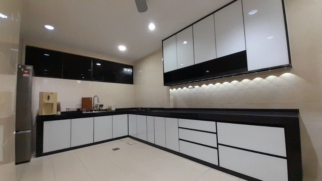 A wide L-shaped kitchen with white gloss lower doors, black trim, dark gloss upper cabinets, a stainless fridge and a tiled floor.